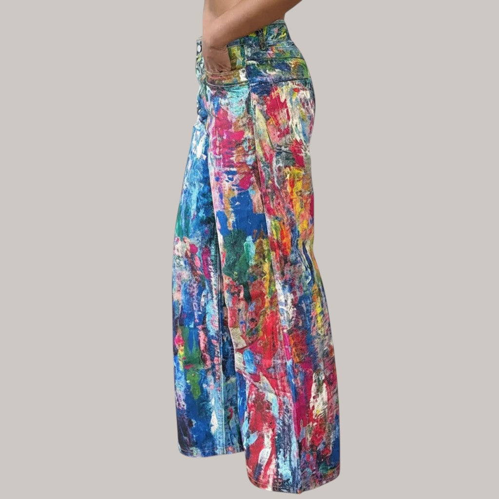MICHEL Artist wide-leg pants featuring a vibrant multi-colored abstract paint splatter print and high-waisted fit.
