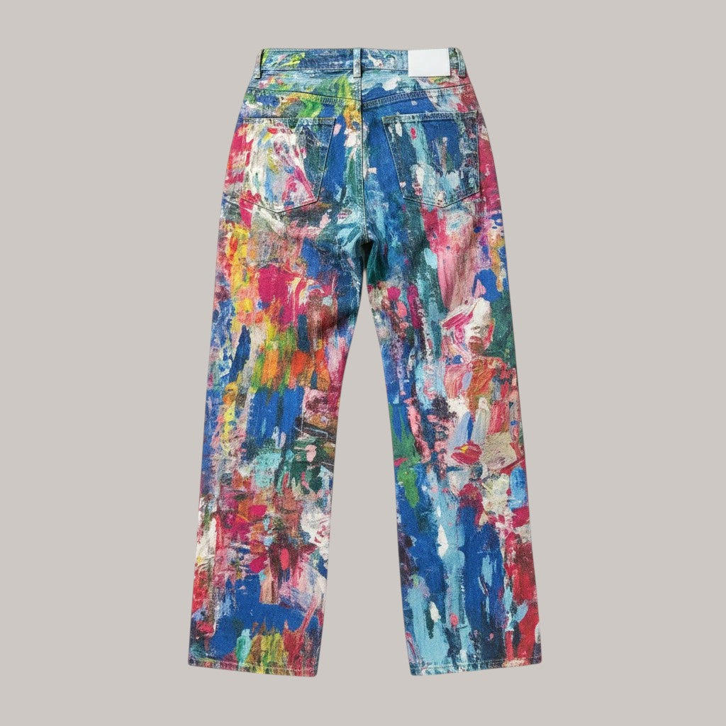 MICHEL Artist wide-leg pants featuring a vibrant multi-colored paint splatter print on denim, back view.