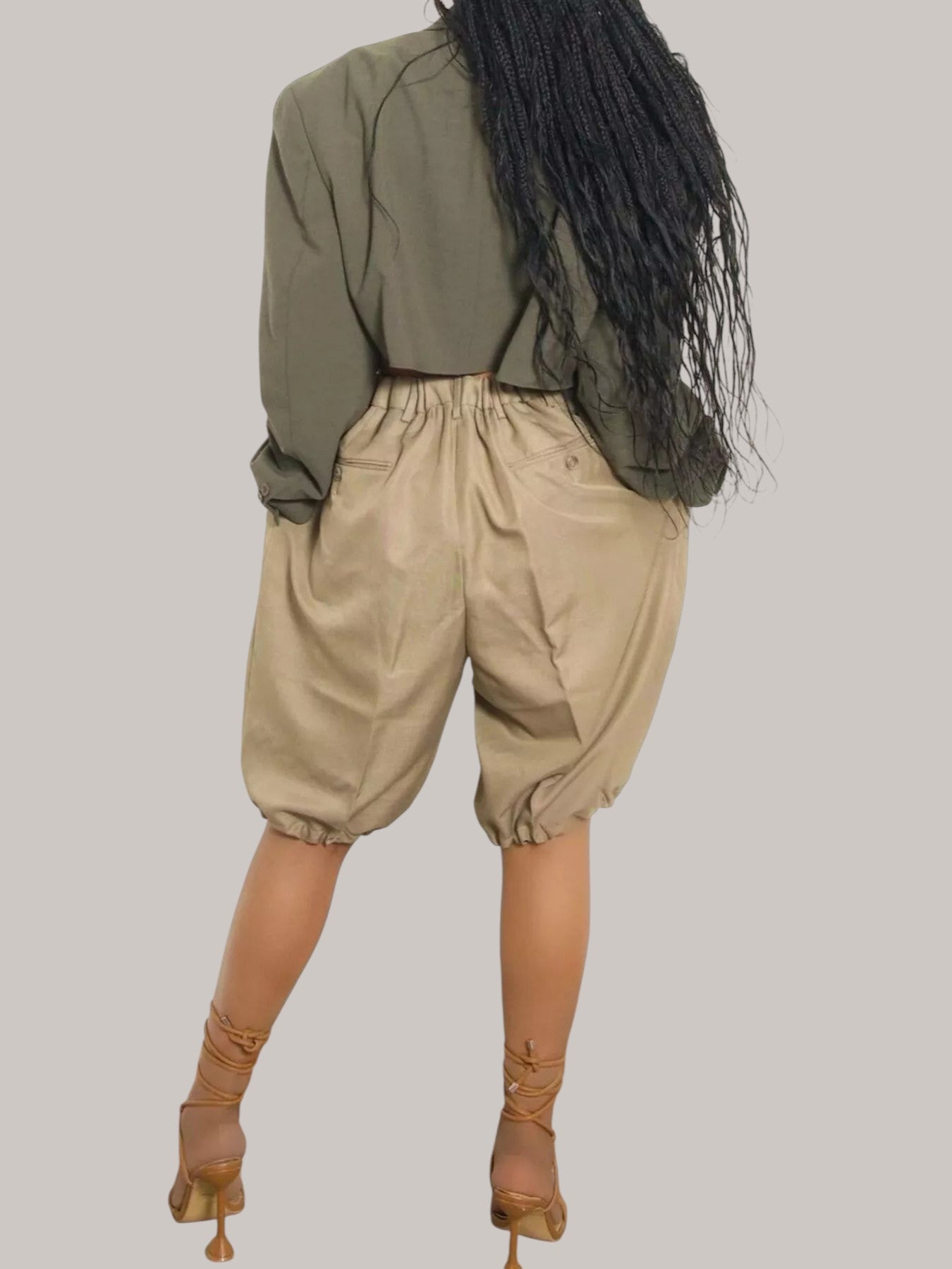 MICHEL high waist pleated shorts in beige with drawstring waist and elastic cuffs worn with lace-up heels