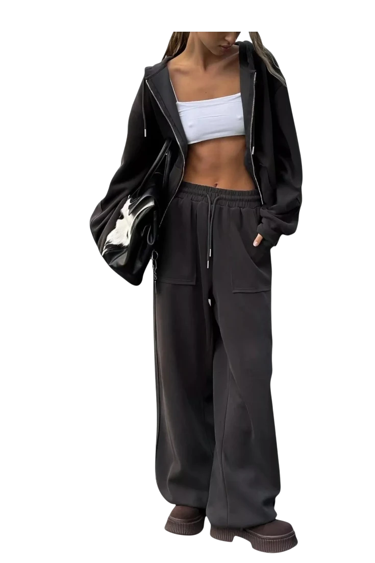 MICHEL oversized black zip-up hoodie and wide-leg pants set with pockets and drawstring, worn with a white crop top