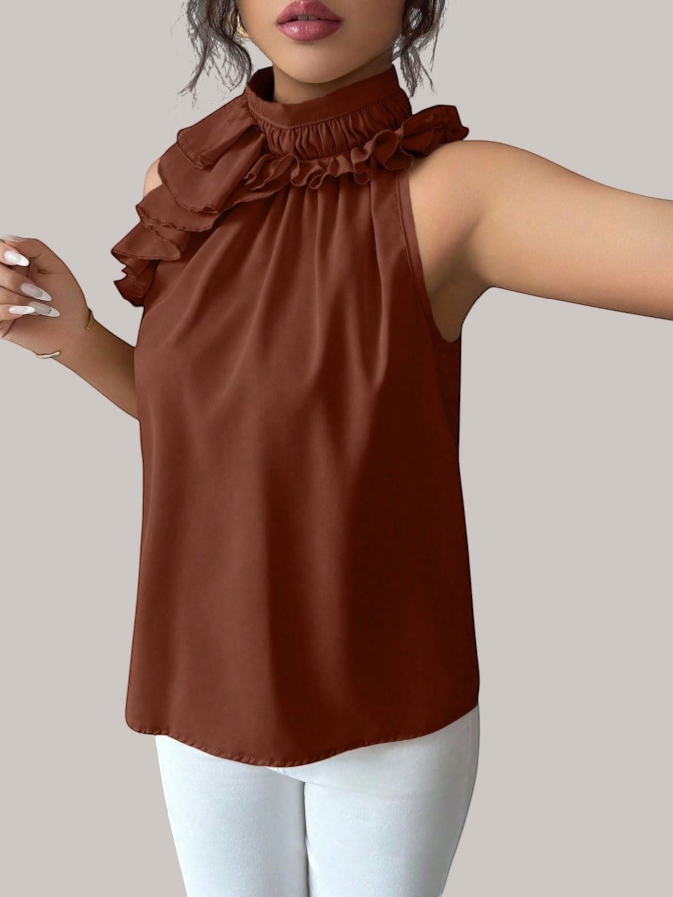 MICHEL brown sleeveless high neck top with ruffled collar detail worn by a model