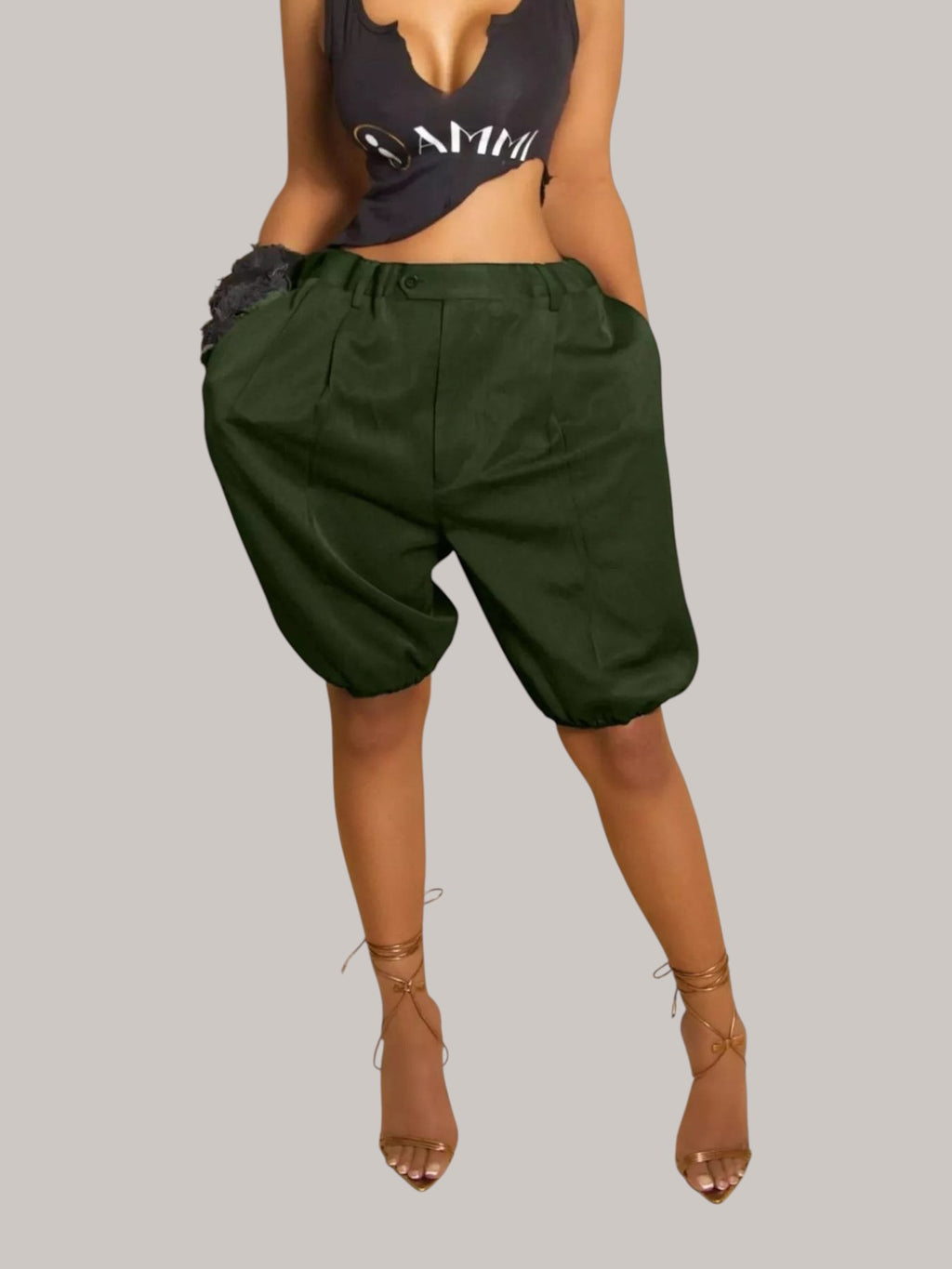 MICHEL dark green high-waisted pleated shorts with drawstring waist and side pockets worn by a model