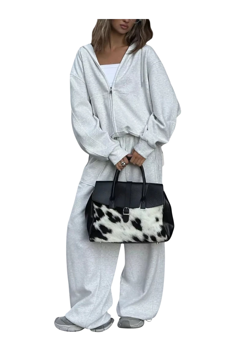 MICHEL oversized grey zip-up hoodie and matching wide-leg pants set worn with a cow print handbag