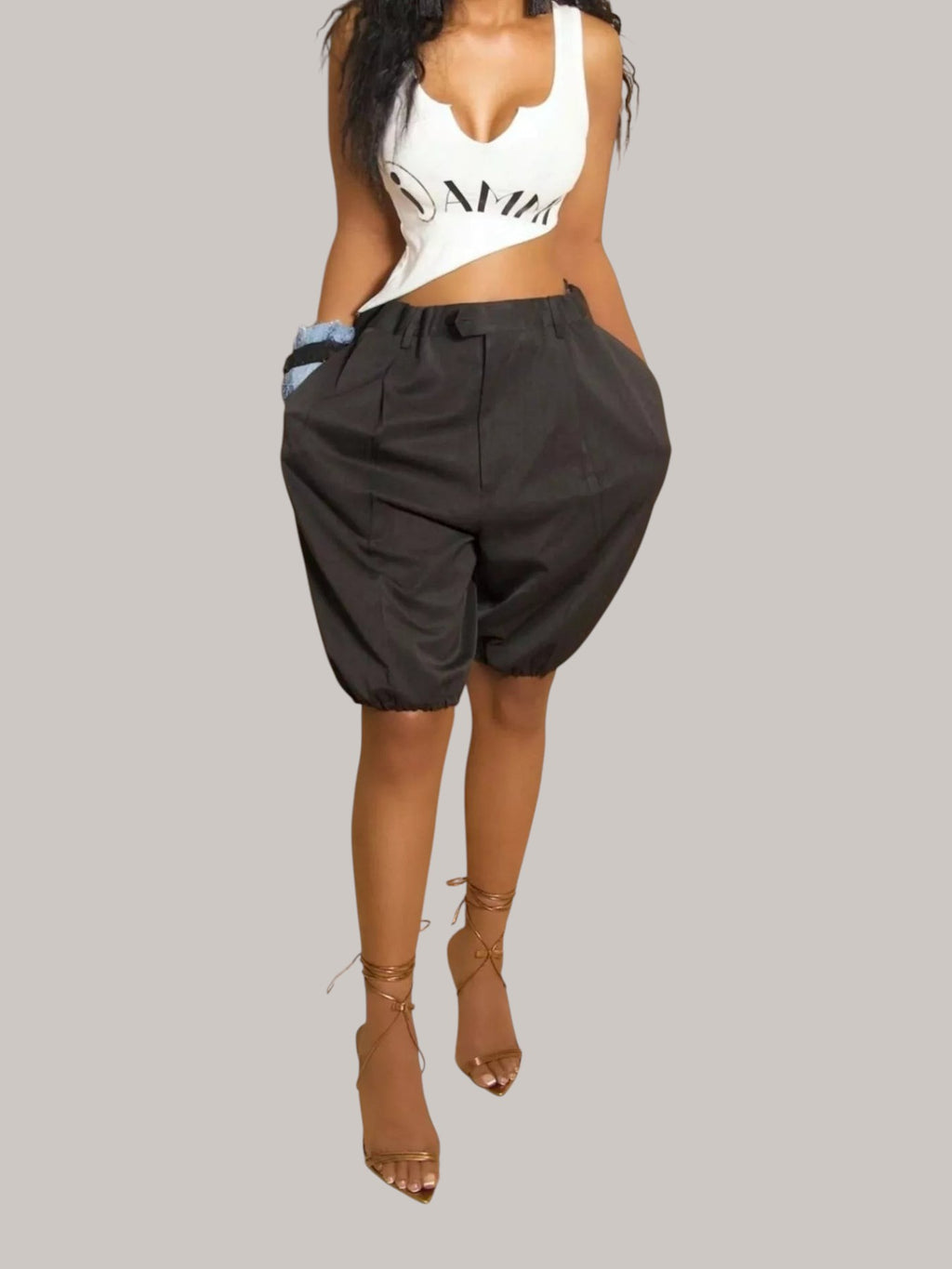 MICHEL high waist black pleated shorts with drawstring and pockets worn by a model with a white crop top