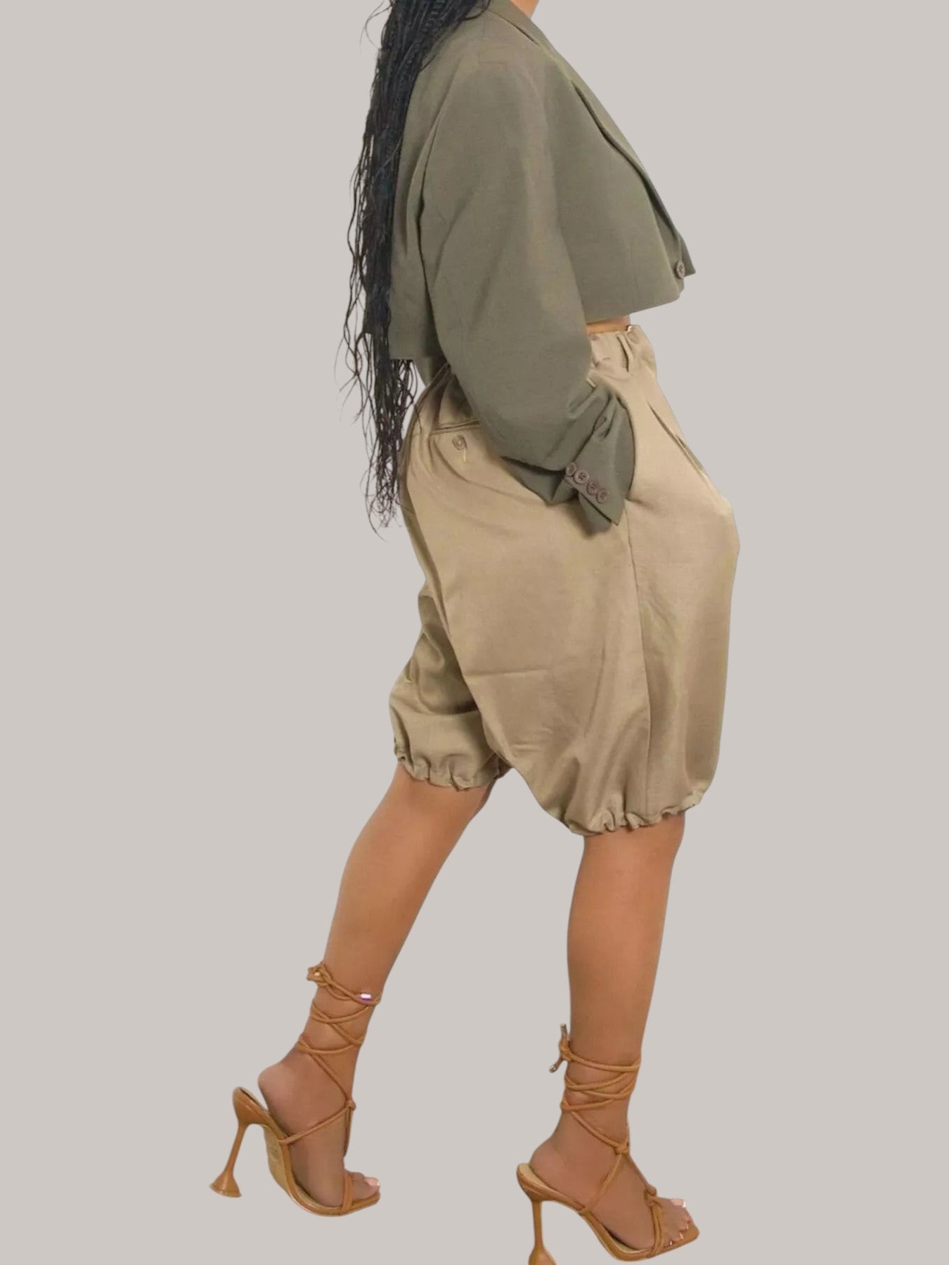 MICHEL high waist pleated shorts in beige with drawstring and pockets, paired with a cropped olive green blazer.