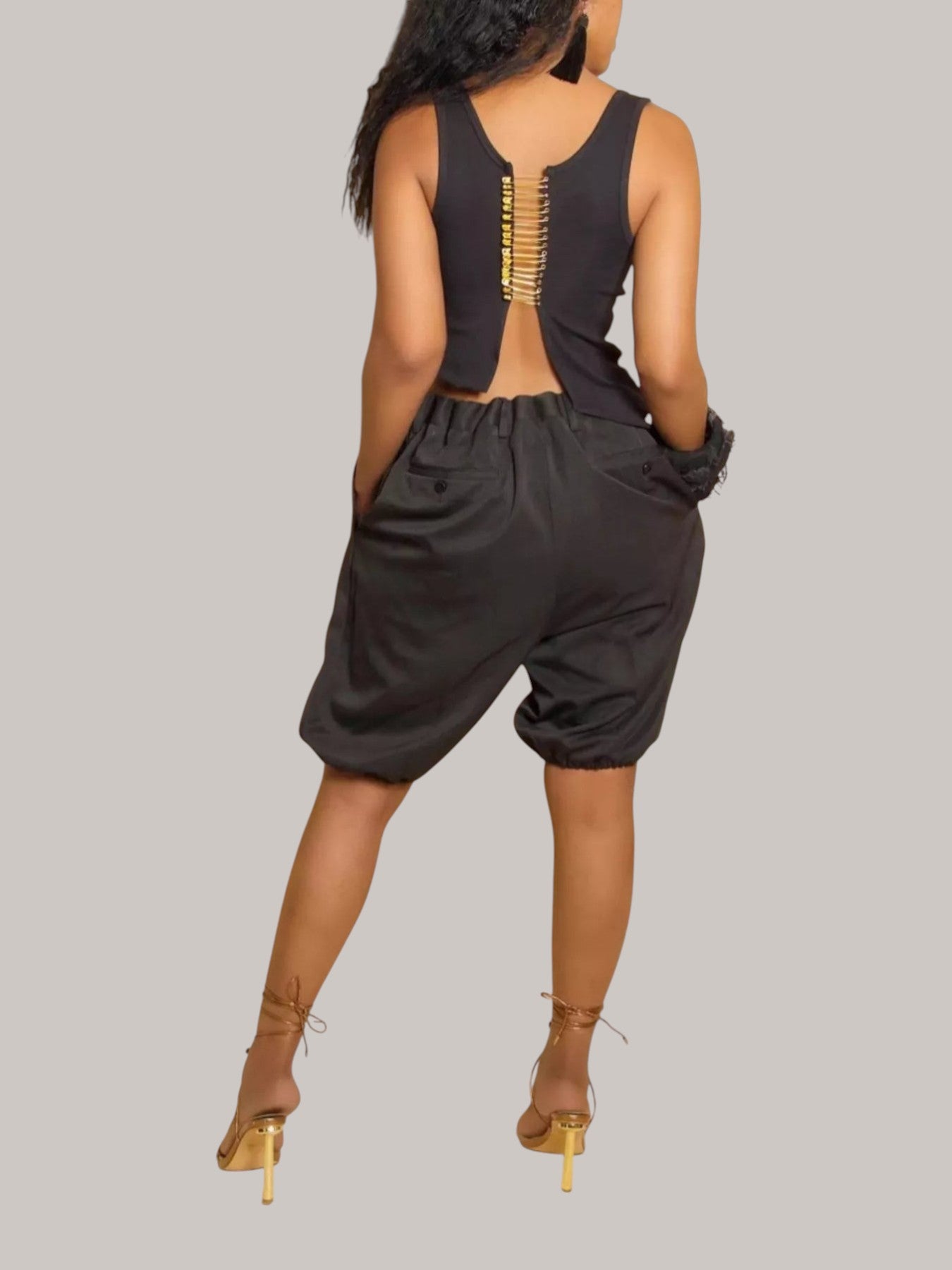 MICHEL high waist pleated shorts in black polyester blend with drawstring and pockets, worn by a model from behind.