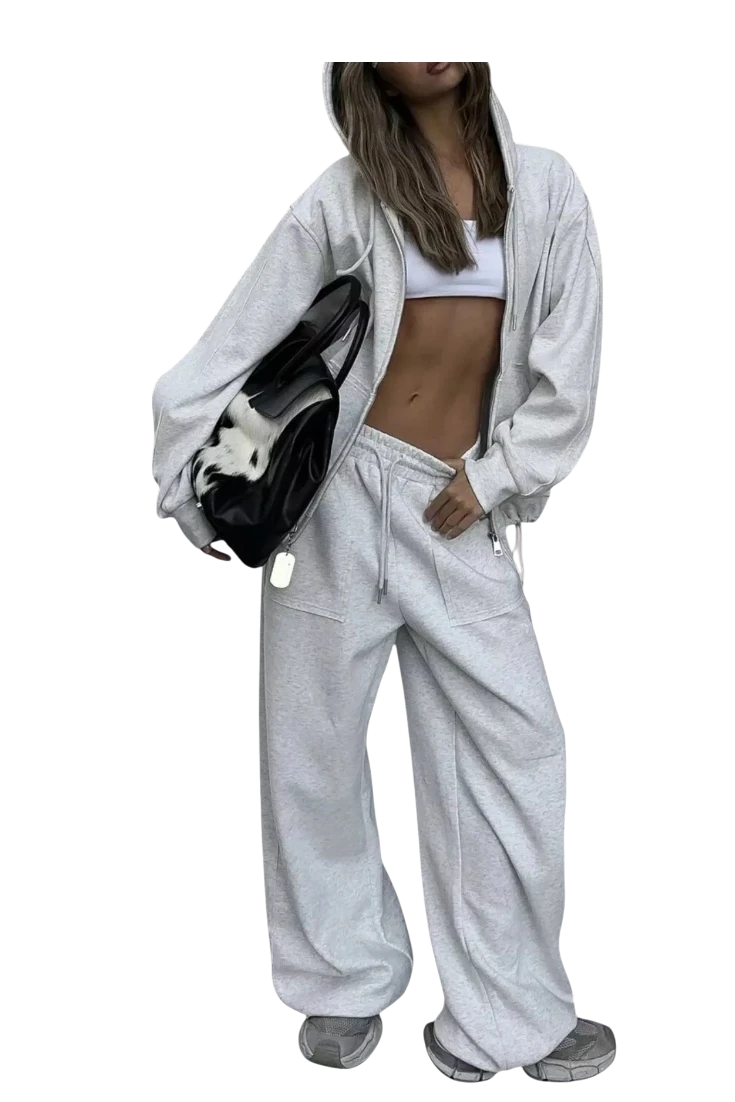 MICHEL oversized grey zip-up hoodie and matching wide-leg drawstring pants set worn by a model with a black bag