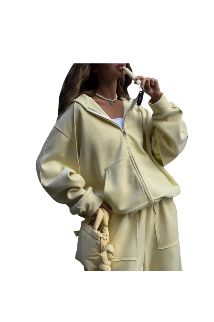 MICHEL oversized pale yellow zip-up hoodie and matching wide-leg pants set with pockets and drawstring waist.
