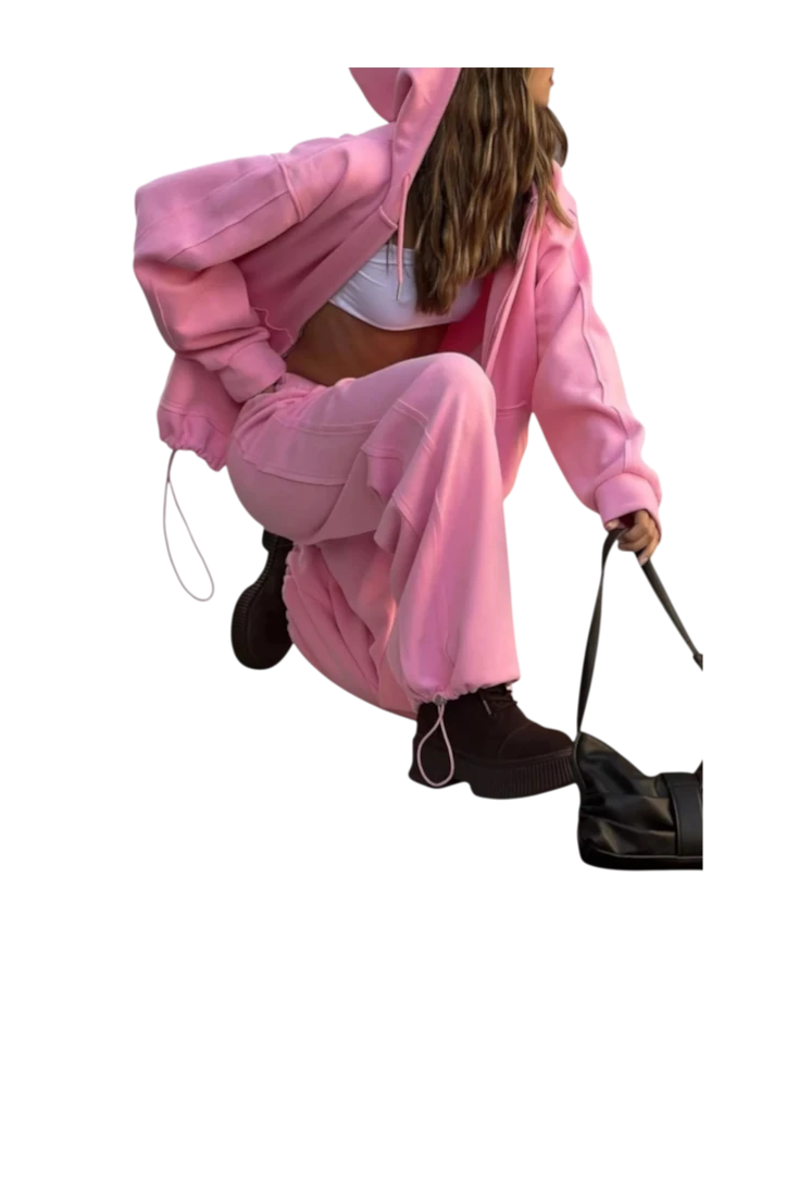 MICHEL pink oversized zip-up hoodie and wide-leg drawstring pants two-piece set worn by a model with a black bag.