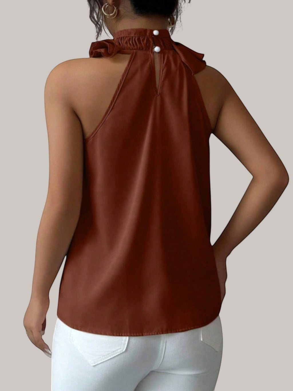 MICHEL sleeveless top in rust brown featuring a high ruffled neck and back button closure on a model