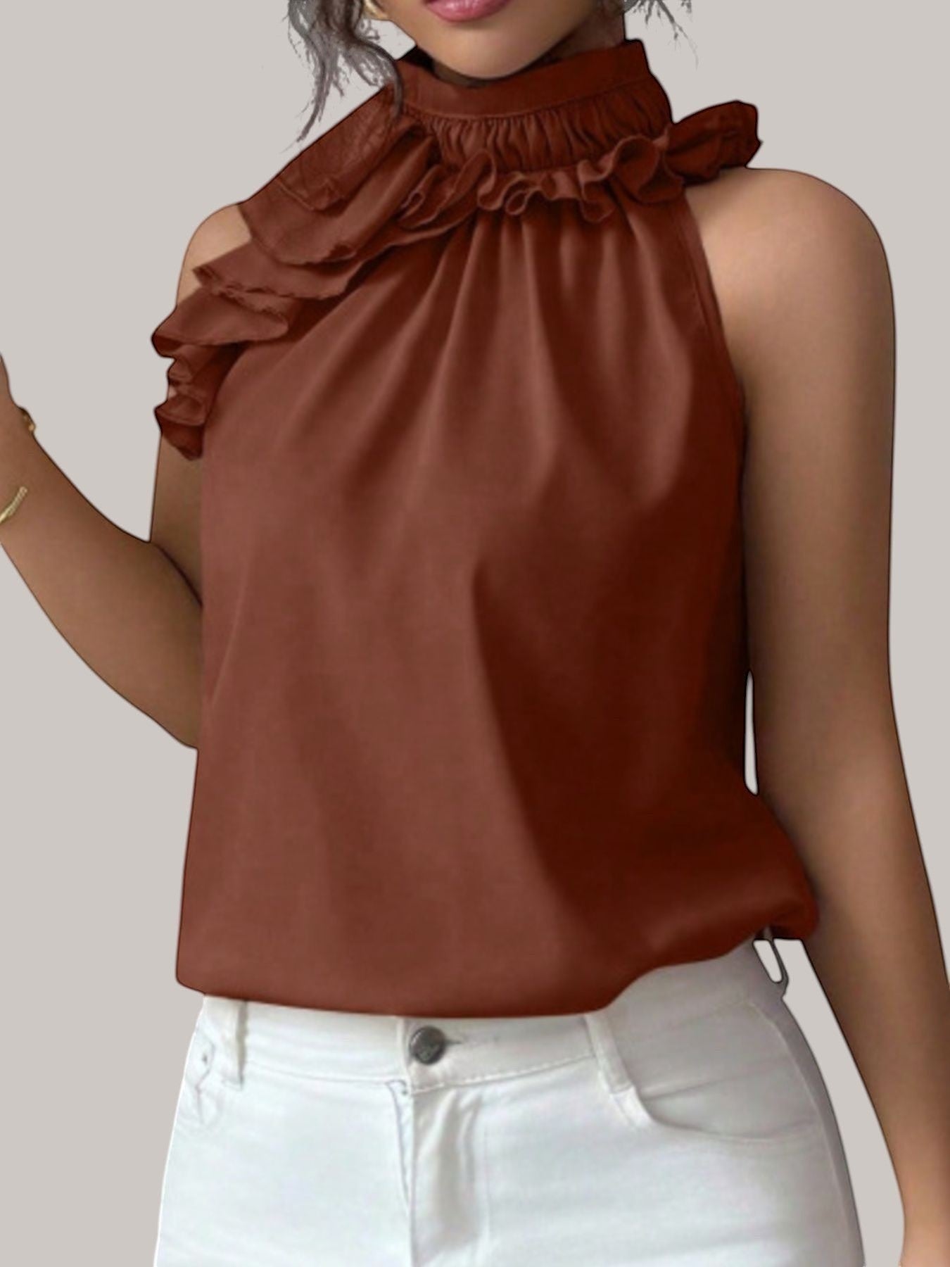 MICHEL sleeveless top in rust brown with a high ruffled neck and button detail, worn by a model.